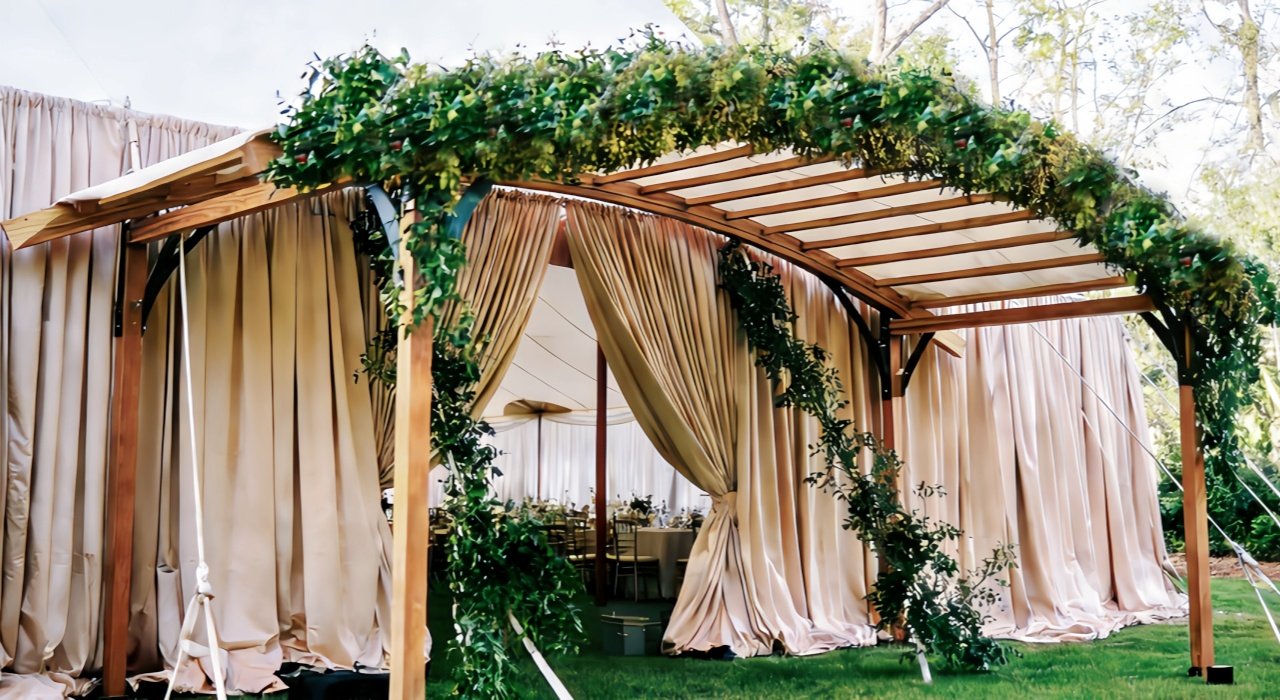 Wooden Arch Adorned with Greenery for wedding tents