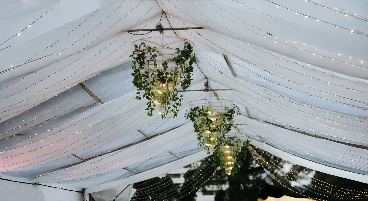 Striking Chandeliers with Greenery for wedding tent decoration ideas